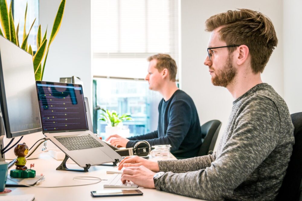 Two software developers are doing some work on computers